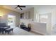 Well-lit living room featuring a cozy chair, built-in shelving, and a view to the home's staircase at 25962 High Hampton Cir, Sorrento, FL 32776