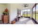 Covered patio featuring comfortable seating, a ceiling fan, and views of the landscaped backyard at 25962 High Hampton Cir, Sorrento, FL 32776