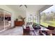 Inviting covered patio offering a dining area and glimpses of the modern kitchen through sliding glass doors at 25962 High Hampton Cir, Sorrento, FL 32776