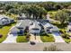 Aerial view of home showcasing well-maintained landscaping, a two-car garage, and a serene setting at 26032 Newcombe Cir, Leesburg, FL 34748
