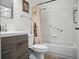 Bathroom featuring modern vanity, updated fixtures, and tile shower with patterned curtain at 26032 Newcombe Cir, Leesburg, FL 34748