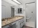 Bathroom featuring vanity with granite counters, tile flooring, and a separate toilet room at 26032 Newcombe Cir, Leesburg, FL 34748