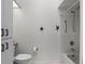 Bathroom with white tile shower and tub combo, updated fixtures, and rustic wall decor at 26032 Newcombe Cir, Leesburg, FL 34748