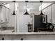 Modern kitchen featuring stainless steel appliances, granite countertops, and stylish pendant lighting at 26032 Newcombe Cir, Leesburg, FL 34748