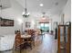 Cozy living room with wood floors, recessed lighting, and sliding glass doors leading to the outside at 26032 Newcombe Cir, Leesburg, FL 34748