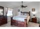 Comfortable main bedroom featuring a ceiling fan, neutral walls, and warm carpeting at 26032 Newcombe Cir, Leesburg, FL 34748