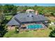 Aerial view of a property featuring a screened-in pool, lush landscaping, and a well-maintained backyard at 2756 Sequoyah Dr, Haines City, FL 33844