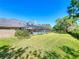 Expansive backyard with a screened-in pool, lush greenery, and ample space for recreation at 2756 Sequoyah Dr, Haines City, FL 33844