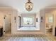 Luxurious bathroom featuring a soaking tub, separate shower, and decorative tile flooring at 2756 Sequoyah Dr, Haines City, FL 33844
