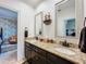 Bathroom vanity featuring double sinks, granite countertop and decorative mirrors at 2756 Sequoyah Dr, Haines City, FL 33844