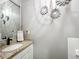 Cozy bathroom featuring a granite countertop, decorative mirrors, and a neutral color scheme at 2756 Sequoyah Dr, Haines City, FL 33844