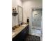 Bright bathroom with double vanity featuring granite countertop and step-in shower at 2756 Sequoyah Dr, Haines City, FL 33844