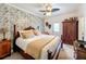 Bedroom featuring patterned wallpaper, ceiling fan, and wooden furnishings at 2756 Sequoyah Dr, Haines City, FL 33844