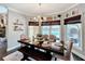 Bright dining area with a view of the backyard pool, complemented by a chandelier and natural light at 2756 Sequoyah Dr, Haines City, FL 33844