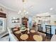 Elegant dining room with a chandelier and hardwood floors, seamlessly flowing into the kitchen at 2756 Sequoyah Dr, Haines City, FL 33844