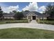 Charming brick home with manicured lawn, mature trees, and long driveway entrance at 2756 Sequoyah Dr, Haines City, FL 33844
