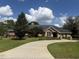 Charming single story brick home features a curved driveway and a well-manicured lawn at 2756 Sequoyah Dr, Haines City, FL 33844