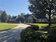 Lovely single Gathering home with a long driveway, manicured lawn, and mature trees creating a welcoming curb appeal at 2756 Sequoyah Dr, Haines City, FL 33844