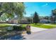 Brick home with a two-car garage, mature trees, manicured hedges, and a well-maintained lawn at 2756 Sequoyah Dr, Haines City, FL 33844