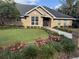 Charming brick home featuring a lush, landscaped front yard and inviting entryway with a wreath-adorned door at 2756 Sequoyah Dr, Haines City, FL 33844