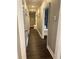 Hallway with hardwood flooring, ample lighting, and built-in bench at 2756 Sequoyah Dr, Haines City, FL 33844