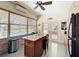 Bright kitchen with granite island, stainless-steel appliances, and pool view at 2756 Sequoyah Dr, Haines City, FL 33844