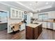 Gourmet kitchen featuring granite countertops, white cabinetry, stainless steel appliances, and an island with cooktop at 2756 Sequoyah Dr, Haines City, FL 33844