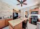 Kitchen with brick walls, granite island, and stainless-steel appliances at 2756 Sequoyah Dr, Haines City, FL 33844