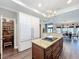 Bright kitchen features white cabinetry, granite countertops, a center island with cooktop, and hardwood floors at 2756 Sequoyah Dr, Haines City, FL 33844