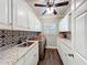 Bright laundry room with stainless steel sink, granite countertops, and ample storage at 2756 Sequoyah Dr, Haines City, FL 33844