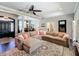 Spacious living room with dark wood floors, large sectional sofa, and designer accents at 2756 Sequoyah Dr, Haines City, FL 33844