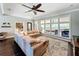 Bright living room with large windows overlooking the pool, features a sectional sofa and patterned rug at 2756 Sequoyah Dr, Haines City, FL 33844