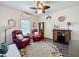 Cozy living room featuring ceiling fan, red leather recliners, and unique decor at 2756 Sequoyah Dr, Haines City, FL 33844