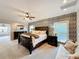 Spacious main bedroom with decorative wallpaper, an ornate bed frame, and ample natural light at 2756 Sequoyah Dr, Haines City, FL 33844