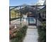 Screened-in pool area featuring a sparkling pool, patio furniture, and a well-maintained outdoor space at 2756 Sequoyah Dr, Haines City, FL 33844