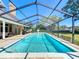 Beautiful screened-in pool surrounded by lush landscaping, offering a private outdoor oasis at 2756 Sequoyah Dr, Haines City, FL 33844