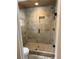 Modern walk-in shower featuring glass door, neutral tile, and built-in niche at 2756 Sequoyah Dr, Haines City, FL 33844