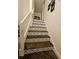 Charming staircase features stained wood steps complemented with decorative tile risers and a white handrail at 2756 Sequoyah Dr, Haines City, FL 33844