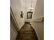 Classic staircase features stained wood steps, a white handrail and trim, plus decorative wall art and chandelier at 2756 Sequoyah Dr, Haines City, FL 33844