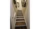 Stylish staircase features stained wood steps complemented with decorative tile risers and framed wall art at 2756 Sequoyah Dr, Haines City, FL 33844