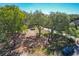Picturesque aerial view of a landscaped yard with mature trees and a distant trampoline at 2756 Sequoyah Dr, Haines City, FL 33844