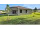 Rear exterior view of home with sliding glass doors opening to a spacious backyard at 2980 Supermarine Rd, Tavares, FL 32778