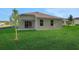 Rear exterior view of home with sliding glass doors opening to a spacious backyard at 2980 Supermarine Rd, Tavares, FL 32778