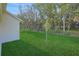Large backyard featuring lush green lawn and wooded backdrop, perfect for outdoor enjoyment at 2980 Supermarine Rd, Tavares, FL 32778