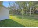 Large backyard featuring lush green lawn and wooded backdrop, perfect for outdoor enjoyment at 2980 Supermarine Rd, Tavares, FL 32778