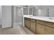 Modern bathroom featuring a glass-enclosed shower and double sink vanity at 2980 Supermarine Rd, Tavares, FL 32778