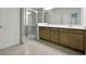 Modern bathroom featuring a glass-enclosed shower and double sink vanity at 2980 Supermarine Rd, Tavares, FL 32778