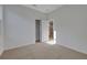 Bright, airy bedroom with neutral carpeting, white walls, and a closet at 2980 Supermarine Rd, Tavares, FL 32778