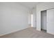 Bright, airy bedroom with neutral carpeting, white walls, and a closet at 2980 Supermarine Rd, Tavares, FL 32778