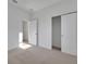 Bright, airy bedroom with neutral carpeting, white walls, and a closet at 2980 Supermarine Rd, Tavares, FL 32778